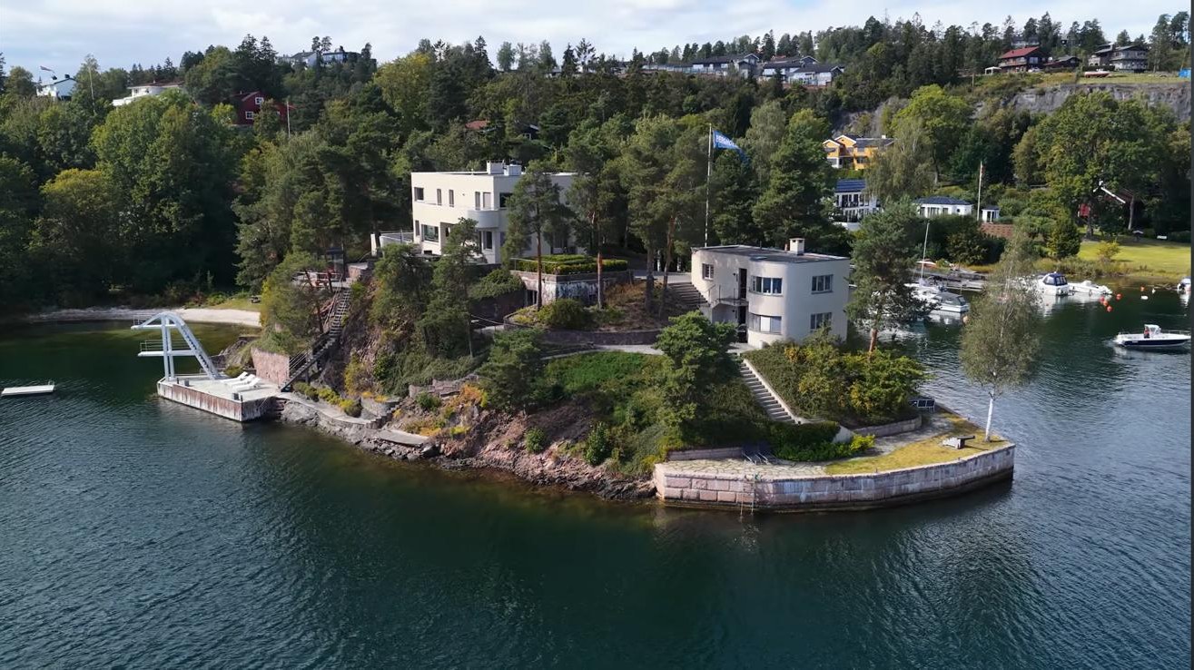 Our first House: a white villa on a forested headland by the inner Oslofjord, with a pier and diving tower by the water